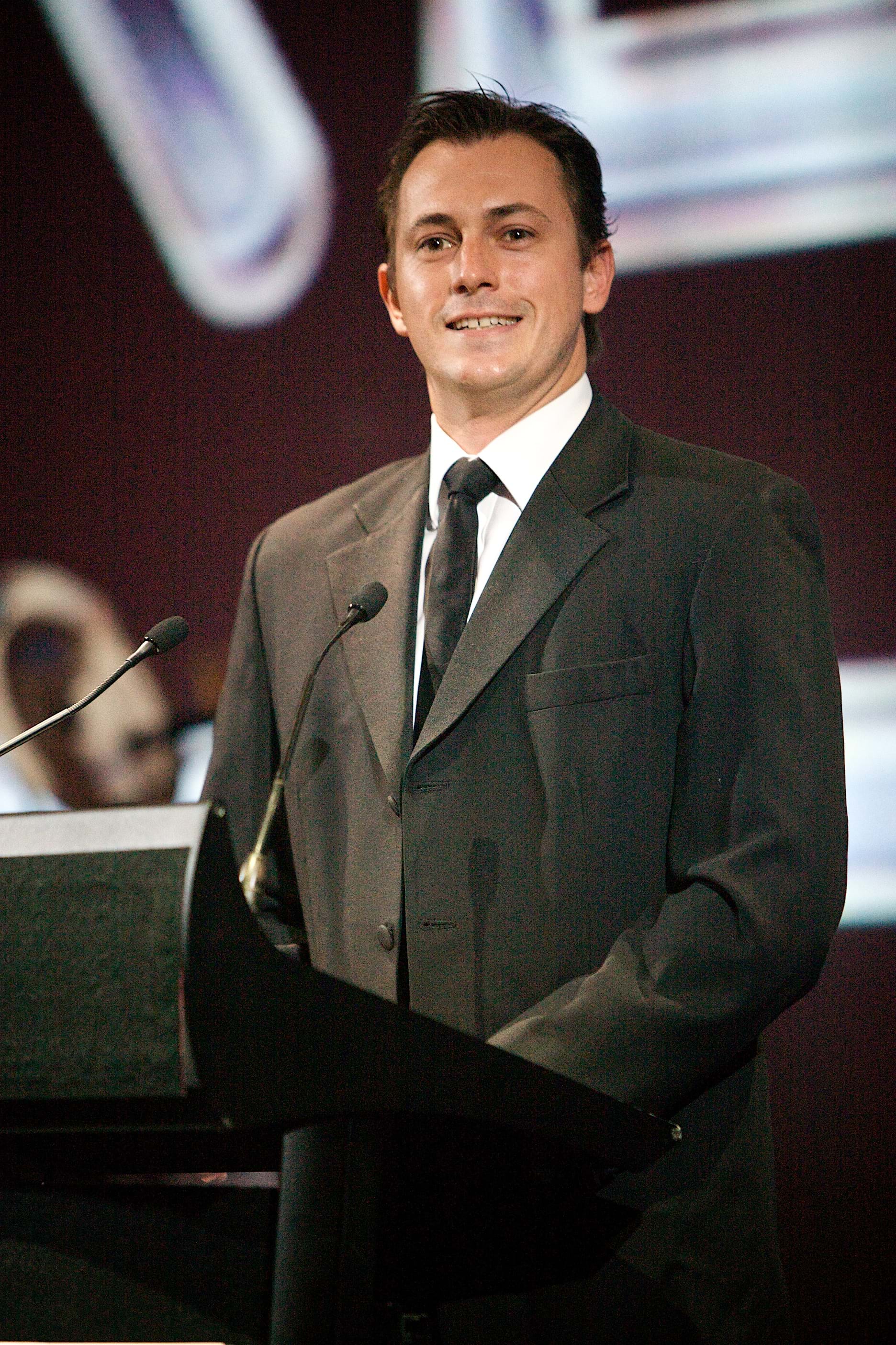 Blair Mcdonough on stage at Melbourne charity event Red Ball raising funds for Fight Cancer Foundation.